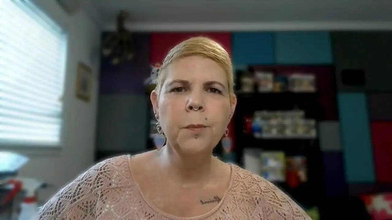Person in lace top in colorful room.